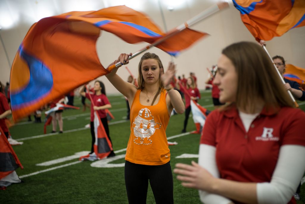 Natasha Olejar a senior marketing and retail management major, follows along with the Rutgers color guard at the practice field on Rutgers' campus on Sunday morning. It was the first time the two bands played together on the morning of the Super Bowl.