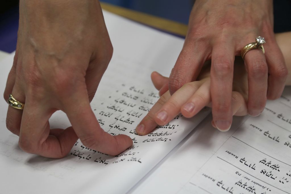 Due to the dual curriculum with both general and Judaic studies, learning opportunities are vast. The dynamic program enables students to learn the Hebrew language as well as the history of the Jewish religion. Mrs. Zames helps first-grader Isaac Bloom follow along with the class as they chant prayers during Hebrew on September 23, 2016.