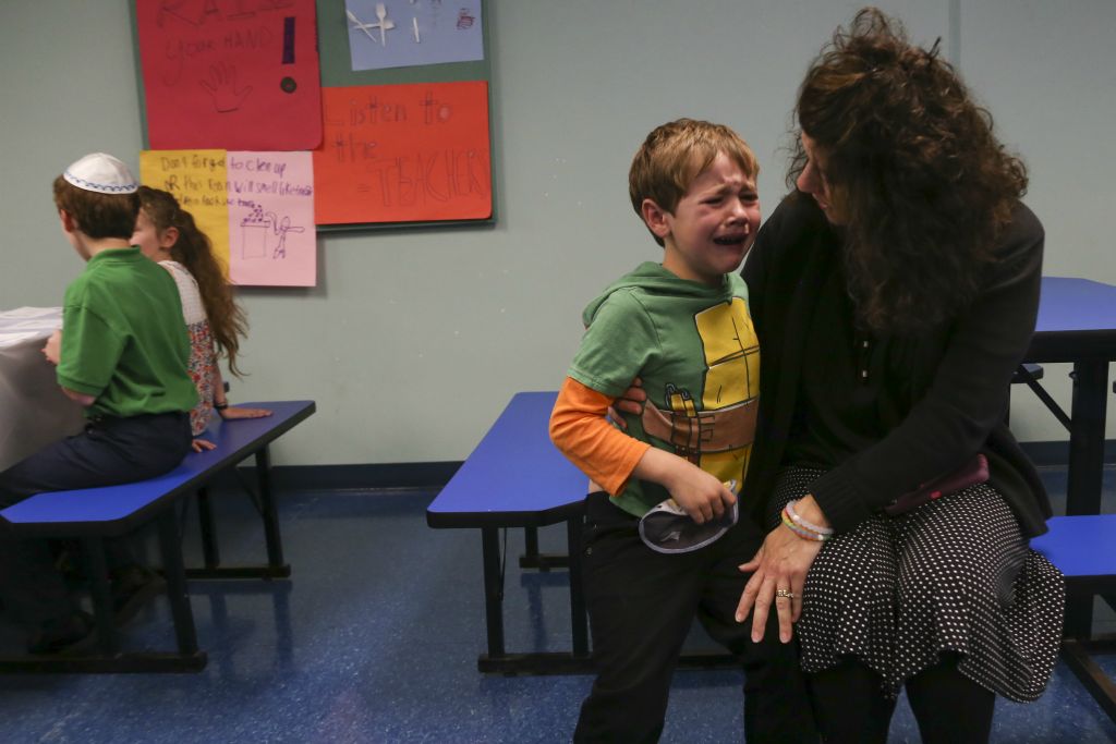 Mrs. Rose comforts Samuel Vickery after he ran into a bench during lunch on October 7, 2016. Head of School Lori Tenenbaum comments that she never liked the new addition of the tables, but they were a parting gift to her from the former head of school.