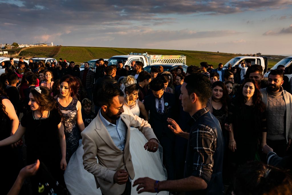 Amar and Salih, cousins of the bride, dance following the wedding ceremony of Amera and Samir. Several hundred from the Yazidi community turned out for an afternoon and evening of celebration; at the end of the night all of the guests returned to the tents they have called home for the past four years. Each of the nearly 9,000 individuals who live in the camp are displaced Yazidis from Sinjar and have been living in the camp since the August 2014 ISIS siege that left thousands dead, thousands captured and that still today leaves tens of thousands unable to return to their homes.