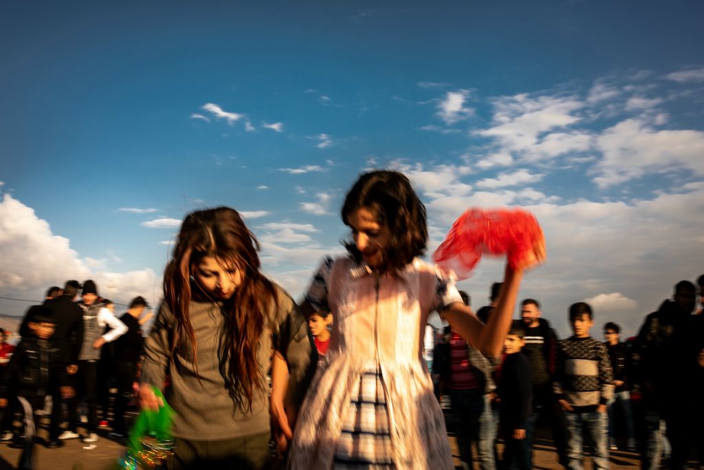Mahr and Samina participate in a Yazidi wedding celebration outside the Bajed Kandala Yazidi displacement camp. The girls were among several hundred from the Yazidi community to attend the wedding of Samir and Amera. After fleeing the August 2014 ISIS attack on Sinjar, both girls arrived to the camp before their fifth birthdays and shared that they cannot remember much about their homes or their former lives in Sinjar.