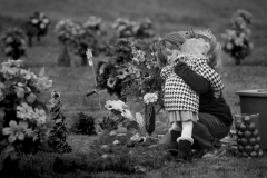 Melanie Hack, embraces her younger daughter Zoey, 3, near Reagan’s grave at Monroe County Memorial Lawn in Tompkinsville, Kentucky. While other mothers' buy Christmas gifts for their children, Melanie buys ornaments and flowers to decorate her daughter’s grave.