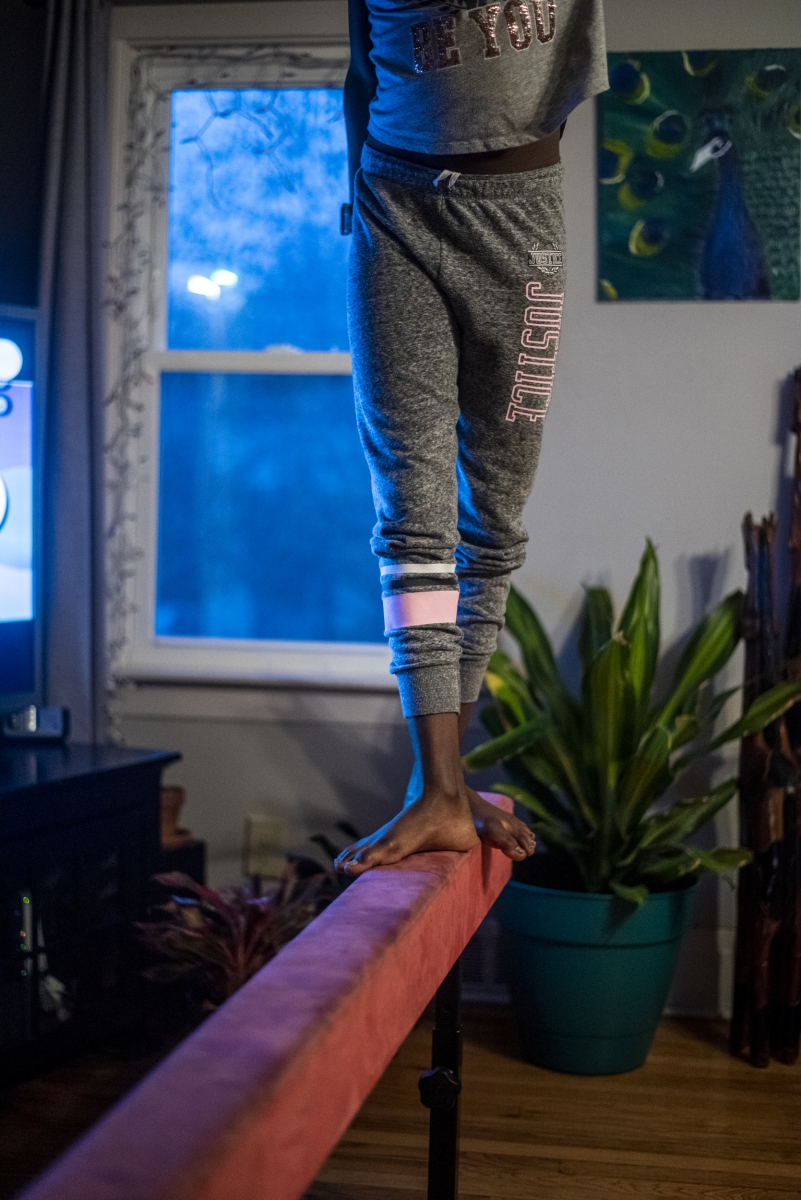 Aubrey  walks on her balance beam in her family's living room in Syracuse, NY on Nov. 10, 2019.