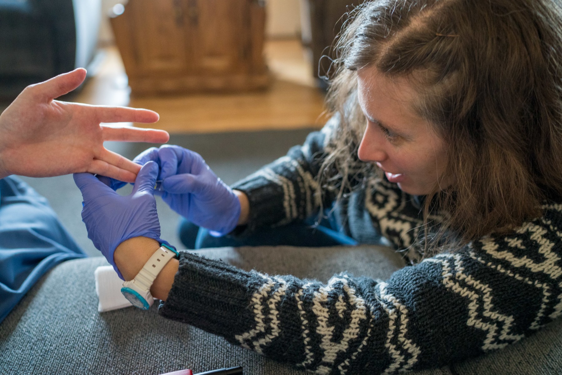 Lauren takes a blood sample from Mandy Yoder's to check for iron deficiency on an Amish farmhouse  in Hamden, Ohio.