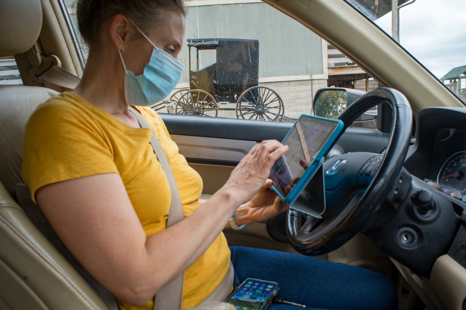 Lauren checks her digital midwife records before going  to  an appointment with an Amish client in Hamden, Ohio. Lauren works with clients living within a sixty-mile radius of Athens, and about half of her clients are from the Amish communities in Vinton, Athens, and Morgan Counties.