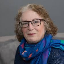 Senior woman with blue scarf and glasses